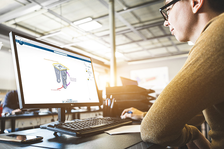 Designer looking at screen with markup on 3D model - SOLIDWORKS Cloud Services