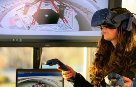 a woman using virtual reality and displaying the image on a monitor